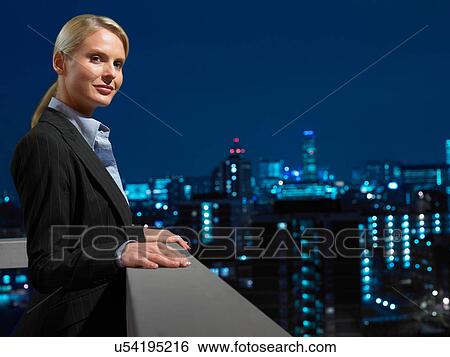 Smart lady in corporate environment overlooking the city View Large Photo Image Stock Photograph - Smart lady in corporate environment overlooking the city. Fotosearch