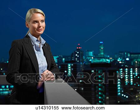 Smart lady in corporate environment overlooking the city View Large Photo Image Stock Photography - Smart lady in corporate environment overlooking the city. Fotosearch