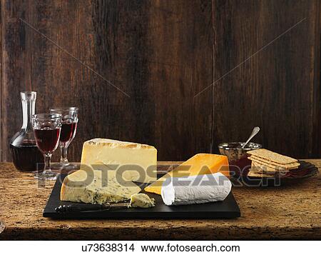 Picture - Speciality Christmas cheeseboard selection. Stilton, goats cheese, red leicester and cheddar with red wine and crackers. Fotosearch