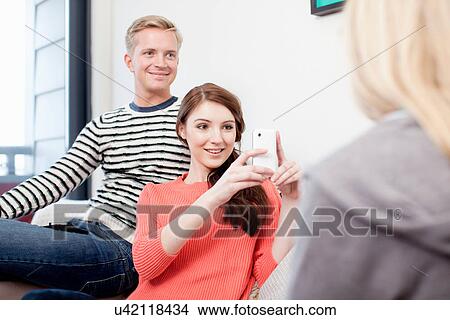 Student using camera phone to photograph friends View Large Photo Image Picture - Student using camera phone to photograph friends. Fotosearch