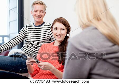 Stock Image - Students with cell phones. Fotosearch