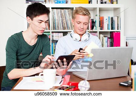 Students working on laptop and digital tablet View Large Photo Image Stock Photo - Students working on laptop and digital tablet. Fotosearch