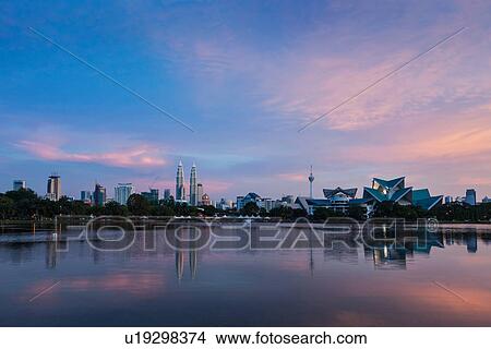 Sunset on Kuala Lumpur cityscape including Petronas Twin Towers over Titiwangsa Lake, Malaysia View Large Photo Image Picture - Sunset on Kuala Lumpur cityscape including Petronas Twin Towers over Titiwangsa Lake, Malaysia. Fotosearch