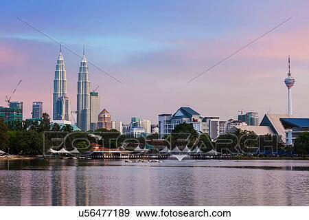 Stock Photo - Sunset on Kuala Lumpur cityscape including Petronas Twin Towers over Titiwangsa Lake, Malaysia. Fotosearch