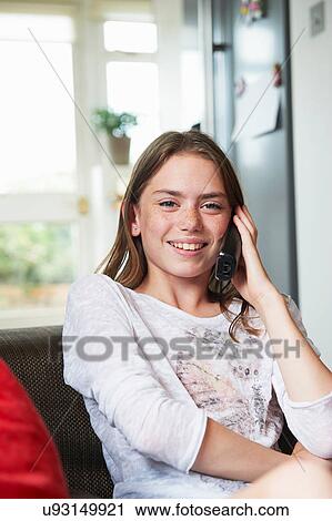 Stock Image - Teenage girl on cordless phone. Fotosearch
