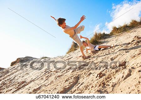 Stock Image - Two boys playing on beach. Fotosearch