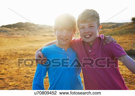 Two boys with arms around each other View Large Photo Image Stock Image - Two boys with arms around each other. Fotosearch