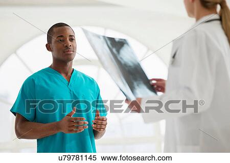 Stock Photography - Two doctors looking at xray. Fotosearch