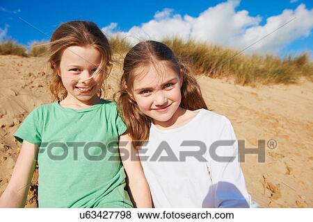 Two girls on beach, portrait View Large Photo Image Stock Photo - Two girls on beach, portrait. Fotosearch