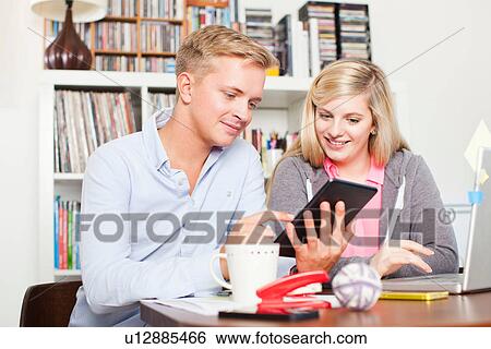 Two students using digital tablet View Large Photo Image Stock Photograph - Two students using digital tablet. Fotosearch