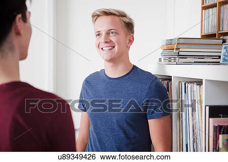Two young men shaking talking View Large Photo Image Stock Photograph - Two young men shaking talking. Fotosearch