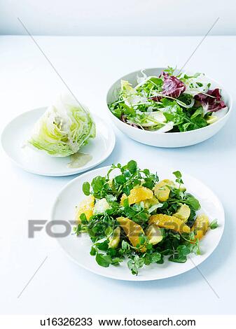 Stock Image - Watercress, avocado and orange salad, iceberg and Italian bitter leaf salad. Fotosearch