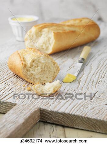 White baguette with butter on white wooden board View Large Photo Image Picture - White baguette with butter on white wooden board. Fotosearch