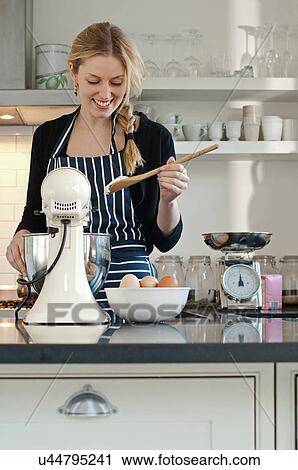 Woman checking consistency of cake mixture View Large Photo Image Stock Image - Woman checking consistency of cake mixture. Fotosearch
