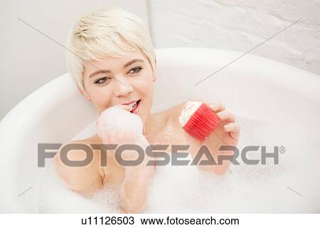 Woman eating cupcake in bubble bath View Large Photo Image Stock Image - Woman eating cupcake in bubble bath. Fotosearch