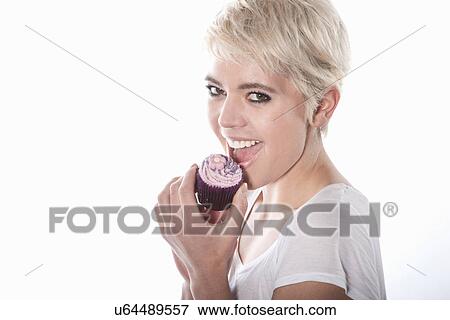 Woman eating cupcake View Large Photo Image Stock Photo - Woman eating cupcake. Fotosearch