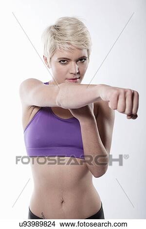 Woman exercising with arm out View Large Photo Image Picture - Woman exercising with arm out. Fotosearch