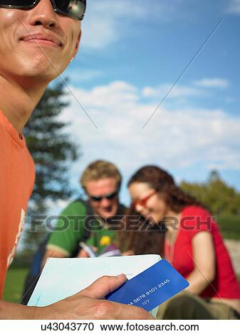 Stock Image - Woman holding credit card. Fotosearch
