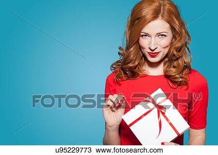 Woman holding white gift box with red bow View Large Photo Image Stock Image - Woman holding white gift box with red bow. Fotosearch