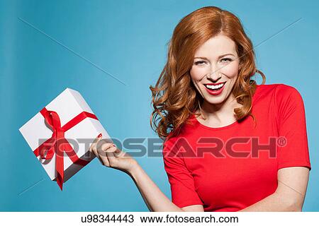 Woman holding white gift box with red bow View Large Photo Image Stock Image - Woman holding white gift box with red bow. Fotosearch
