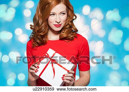 Woman holding white gift box with red bow View Large Photo Image Stock Photo - Woman holding white gift box with red bow. Fotosearch