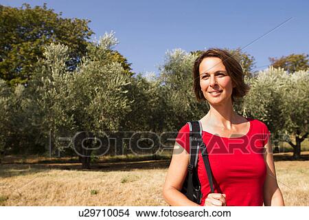 Woman in olive grove, Groznjan, Istria, Croatia View Large Photo Image Picture - Woman in olive grove, Groznjan, Istria, Croatia. Fotosearch