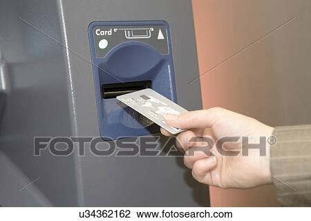 Woman inserting credit card into cashpoint View Large Photo Image Stock Image - Woman inserting credit card into cashpoint. Fotosearch