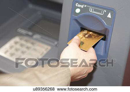 Woman inserting credit card into cashpoint View Large Photo Image Stock Photo - Woman inserting credit card into cashpoint. Fotosearch