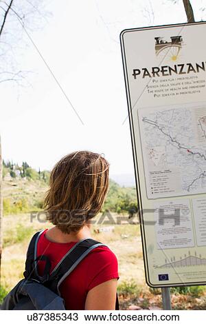 Stock Image - Woman looking at map, Groznjan, Istria, Croatia. Fotosearch