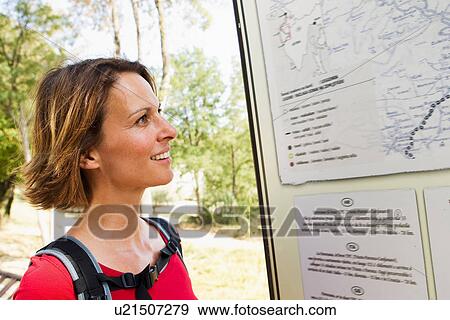 Stock Photo - Woman looking at map, Groznjan, Istria, Croatia. Fotosearch