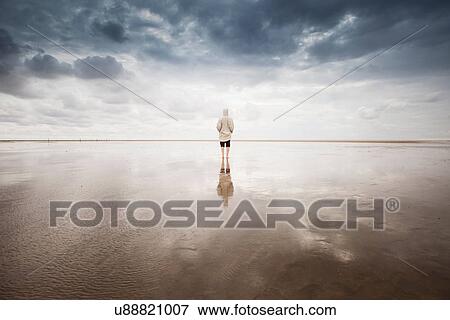 Stock Photo - Woman on beach, Schleswig Holstein, Germany. Fotosearch