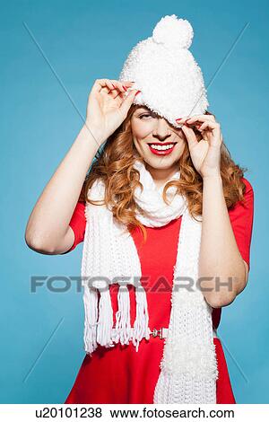 Woman pulling white bobble hat over eyes View Large Photo Image Stock Photo - Woman pulling white bobble hat over eyes. Fotosearch