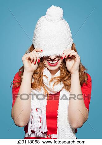 Woman pulling white bobble hat over eyes View Large Photo Image Stock Photo - Woman pulling white bobble hat over eyes. Fotosearch