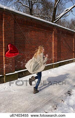 Woman running with red heart-shaped balloon View Large Photo Image Stock Photography - Woman running with red heart-shaped balloon. Fotosearch
