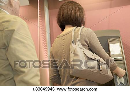 Woman using cashpoint View Large Photo Image Stock Image - Woman using cashpoint. Fotosearch