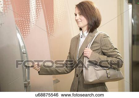 Woman using cashpoint View Large Photo Image Stock Photograph - Woman using cashpoint. Fotosearch
