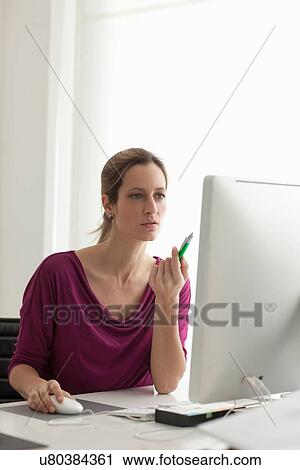 Woman using computer mouse, holding pen View Large Photo Image Stock Image - Woman using computer mouse, holding pen. Fotosearch