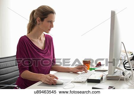 Woman using computer View Large Photo Image Stock Photography - Woman using computer. Fotosearch