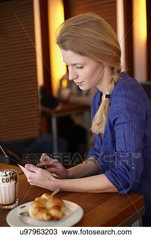 Stock Image - Woman using digital tablet. Fotosearch