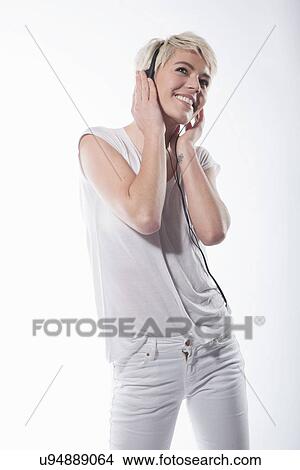 Woman wearing earphones View Large Photo Image Picture - Woman wearing earphones. Fotosearch