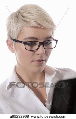 Stock Photo - Woman wearing glasses using digital tablet. Fotosearch