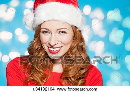 Picture - Woman wearing santa hat. Fotosearch