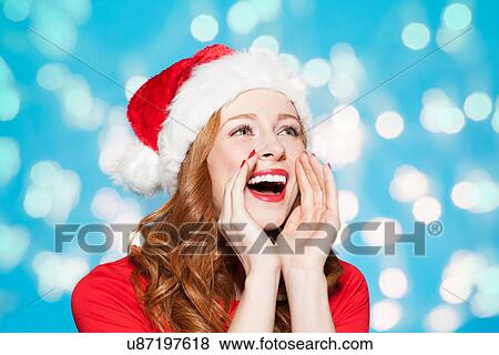 Woman wearing santa hat, shouting View Large Photo Image Stock Photo - Woman wearing santa hat, shouting. Fotosearch