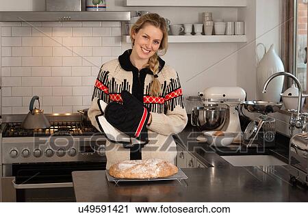 Stock Image - Woman with freshly baked bread. Fotosearch
