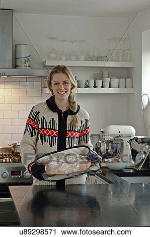 Stock Image - Woman with freshly baked bread. Fotosearch