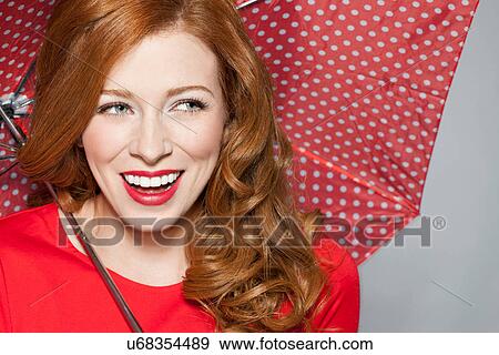 Woman with spotted red umbrella View Large Photo Image Stock Photo - Woman with spotted red umbrella. Fotosearch