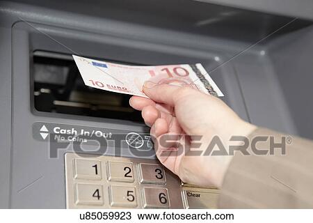 Woman withdrawing ten euro note from cashpoint View Large Photo Image Stock Image - Woman withdrawing ten euro note from cashpoint. Fotosearch