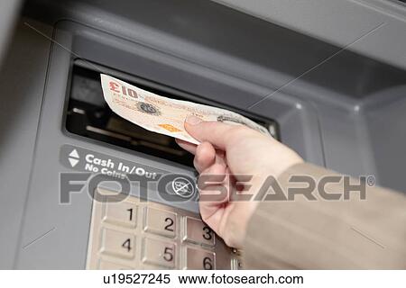 Woman withdrawing ten pound note from cashpoint View Large Photo Image Stock Photography - Woman withdrawing ten pound note from cashpoint. Fotosearch