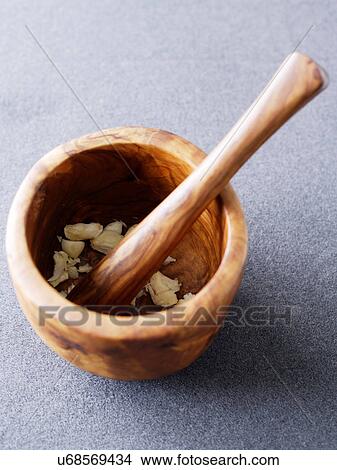 Wooden pestle and mortar with crushed garlic View Large Photo Image Picture - Wooden pestle and mortar with crushed garlic. Fotosearch