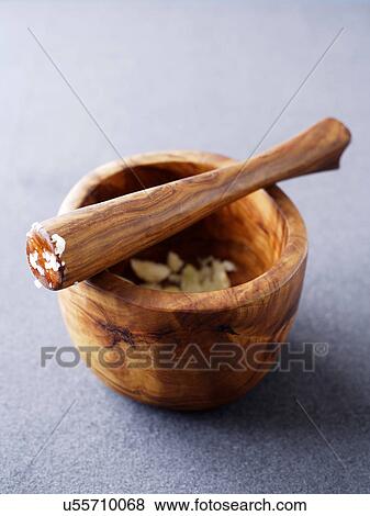 Wooden pestle and mortar with crushed garlic View Large Photo Image Stock Photo - Wooden pestle and mortar with crushed garlic. Fotosearch